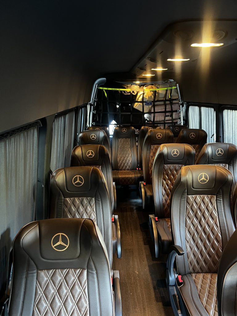 Brown leather seats inside a Mercedes-Benz Sprinter luxury van