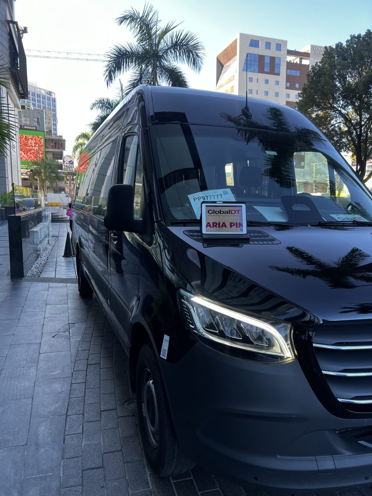 Black Mercedes-Benz Sprinter van on a Punta Cana street during a GlobalDT transfer