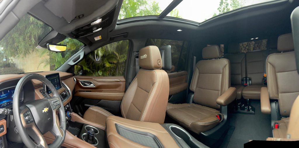 Tan leather interior of a Chevrolet Suburban with panoramic sunroof